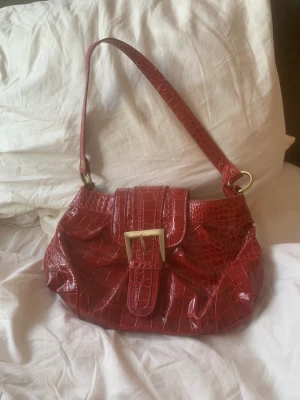 Handväska  - Säljer min röda handväska med leopard mönster på insidan. Säljer den då jag inte använder den! Frakten är 49kr! 