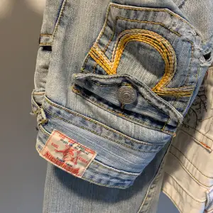 Ljusa true religion jeans med hål på låren. De är i bootcut modell, jag är ca 163,5cm. Bara höra av sig vid frågor. Använd inte köp nu funktionen :)