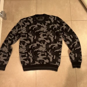 Philipp plein får-ull tröja.  - Riktigt snygg philipp plein tröja med kamouflage mönster.  Endast använd någon enstaka gång, skick 10/10.            Den är stickad i materialet får ull och nypris är ca; 8000-9000kr. Säljer för 3500kr men kan eventuellt diskutera priset.