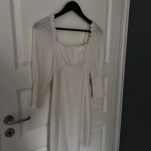 Vit klänning från BikBok - Säljer en söt vit klänning från BikBok i storlek XS. Klänningen har trekvartsärmar och en fin snörning i ryggen. Perfekt för vår och sommar med sin lätta och luftiga design. 💫