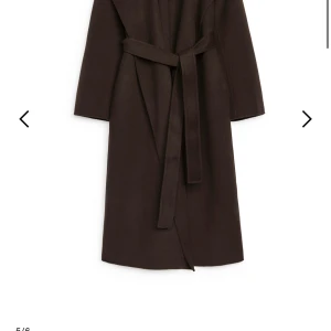 Brun kappa från Arket - ny!  - Brun kappa från Arket med knytbälte i midjan. Har endast använt denna kappa en gång, så den är som ny! Inga fläckar eller anmärkningar alls. 