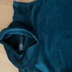 Mörkgrön polotröja från Zara oanvända  - Snygg mörkgrön polotröja från Zara i mjukt material. Perfekt för kyligare dagar med sin stilrena design och långa ärmar. Ett måste i garderoben för en chic look. Skicket är 10/10 eftersom den aldrig är använd! 🤗