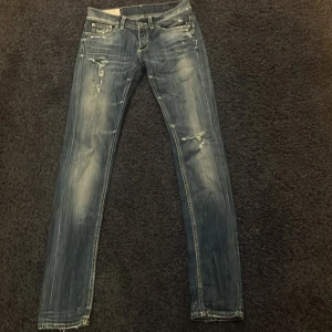 Blå jeans från Dondup - Säljer ett par snygga blå jeans från Dondup. Jeansen är i storlek 26 och är i hyfsat bra skick.