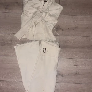 Vit ribbad hoodie och byxa från Catania. - Säljer en vit ribbad hoodie och byxa från Catania. Hoodien är croppad med dragkedja och har långa ärmar. Byxan är en man kan vika. Nypris 1500. Den har en liten fläck på byxan som knappt syns och säljes pga ingen användning. Pris kan diskuteras 💗 storlek small!