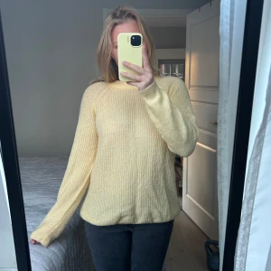 Gul stickad tröja - Mysig gul stickad tröja med långärmad design. Perfekt för kyligare dagar och ger en härlig färgklick till garderoben. Enkel och stilren, passar till många olika outfits.
