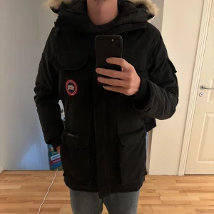 Canada Goose - Säljer en svart parkajacka från Canada Goose med pälsdetalj på huvan. Jackan e grymt skick och en varm jacka för vintern helt klart. nypris 12 tusen jag säljer den för endast 1999:- och priset går att diskutera.