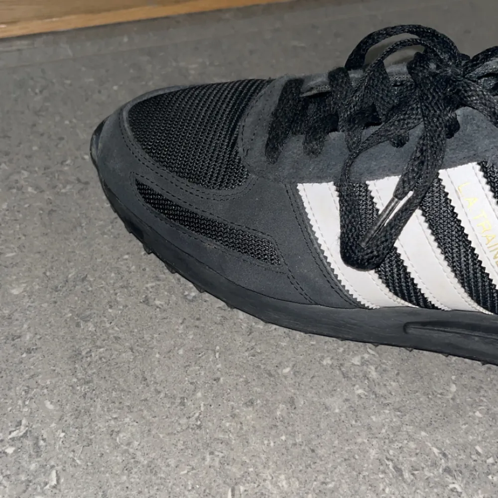 Säljer nu dessa riktigt feta adidas L.A Trainers pga dom inte används, dom är i 8/10 i skick dom har en slitning längst fram i skon syns på bild 2 men inget mer än så, det är ett par riktigt feta skor och passar till allt med en skön svart gul färg👊💯. Skor.