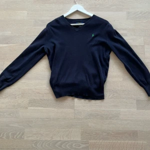 Ralph lauren - Hej! Säljer denna Ralph lauren stickade tröja i barn storlek L men sitter som XS. Har ett hål i armhålan men går enkelt att sy ihop annars väldigt bra skick.