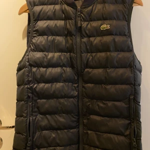 Lacoste dun väste - Snygg dun väst från Lacoste Mörk blå i storlek S/M 