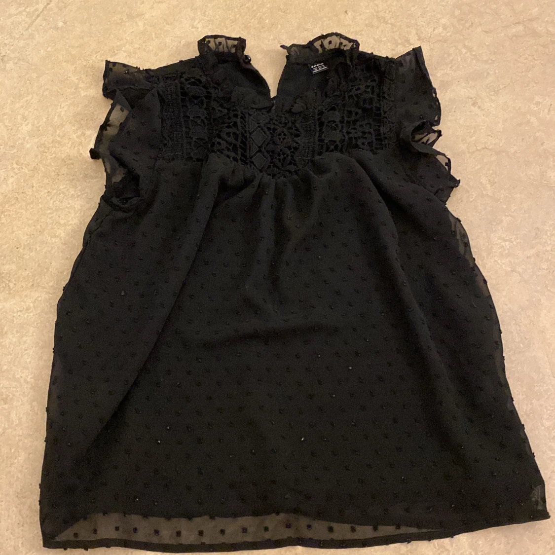 Svart blus med spetsdetaljer