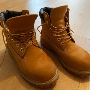 Bruna kängor från Timberland - Säljer ett par klassiska bruna kängor från Timberland i skinn med snörning. Perfekta för höst och vinter med robust sula och bekväm passform. Använda endast ett fåtal gånger förra vintern.