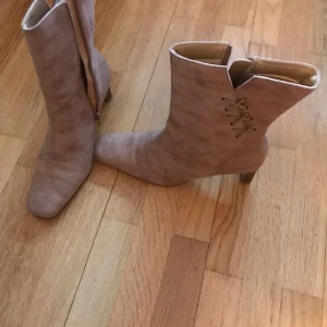 Beige stövletter med dragkedja - Snygga beige stövletter med dragkedja och spetsig tå. Perfekta för höst och vår med en stilren design.