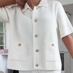 Vit kortärmad stickad från Zara - Säljer en stilren vit kortärmad tröja från Zara. Den har en klassisk krage och knäpps med stora, dekorativa knappar. Helst slutsåld. Strl M men passar xs-l