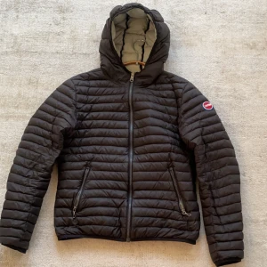 Svart pufferjacka från Colmar - Snygg svart pufferjacka från Colmar med huva och dragkedja framtill. Jackan har ett quiltat mönster och två praktiska fickor med dragkedjor. Perfekt för kyligare dagar. Bra skick förutom två små repor som man ser i tredje bilden!! Skriv vid minsta intresse. Pris ej hugget i sten! Mvh John💛💛🐝🐝✌️✌️