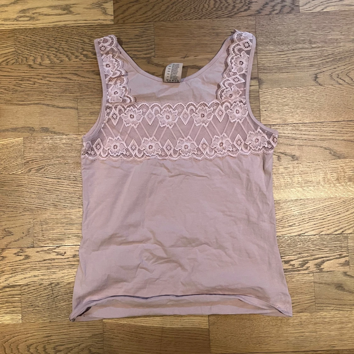 Ljusrosa ärmlös topp med spetsdetaljer