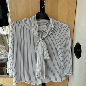 Vacker blåvit knytblus - Superfin blåvit blus med knytning i halsen. Mycket bra skick.