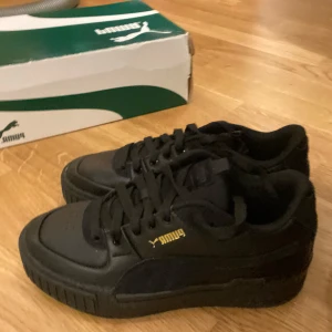 Puma skor - Svarta Puma skor med gulddetaljer. Helt nya och oanvända.  Original kartong finns, Storlek 36, Märke Puma  