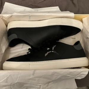 Svarta sneakers Axel Arigato - Snygga svarta sneakers från Axel Arigato med vit sula. Jag säljer dessa par skor pågrund av brist på använding. Ordanarie pris: 2550kr