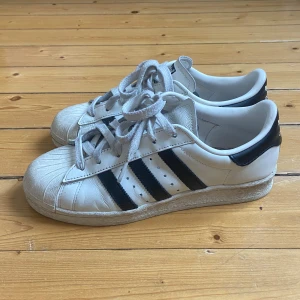 Vita Adidas Superstar sneakers - Klassiska vita Adidas Superstar sneakers, sparsamt använda. 