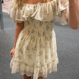 Blommig offshoulder klänning - offshoulder klänning med blommigt mönster och volangdetaljer. Perfekt för sommaren💗💗