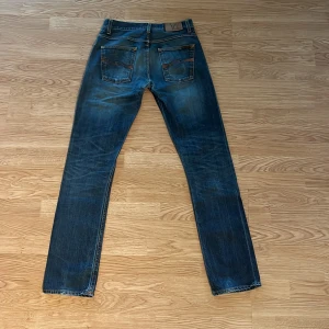 Nudie jeans - Säljer dessa trendiga Nudie Jeans “Lab Tim” i populär mörkblå färg. Bra skick med lite slitage på fickan (se bild 3). Perfekta jeans för den stilmedvetne! Hör av dig för frågor eller fler bilder. Passa på innan de säljs! 👖🍾