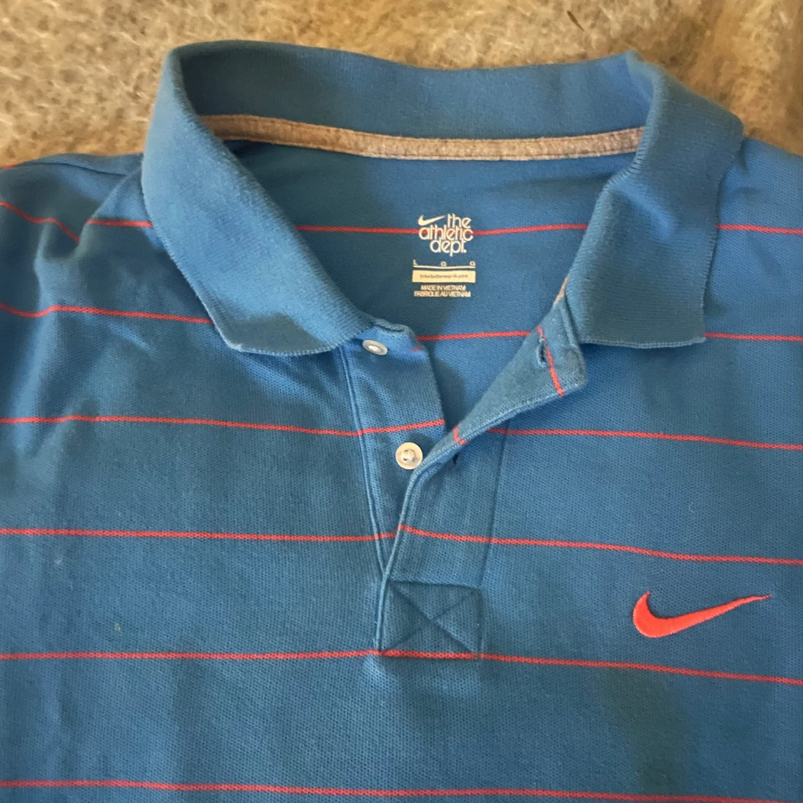 Blå randig pikétröja från Nike - 1