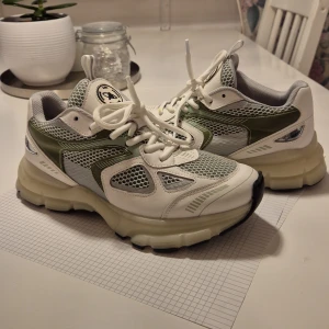 "Marathon Runner" Axel Arigato - Marathon runner sneakers from Axel Arigato in white and green with laces.  The shoes have a chunky sole and mesh details for a modern look.  The sole is slightly glow in the dark, looks really nice! Worn like 4 tines, but figured that dad sneakers are not my thing sadly :).