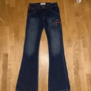 Blå jeans från Levi Strauss - Super coola vintage jeans från Levi Strauss med unika rosa detaljer och broderi på fickor. Jeansen är i mycket bra skick och har en bootcut modell. Säljer de då dem var för stora för mig, priset kan diskuteras!🤍