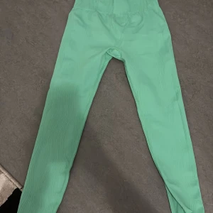 Gröna leggings från H&M Move - Snygga gröna leggings från H&M Move med en unik ribbad textur. Perfekta för träning eller en avslappnad dag. De har en tight passform och är tillverkade i ett stretchigt material för extra komfort. Helt nya aldrig använt 