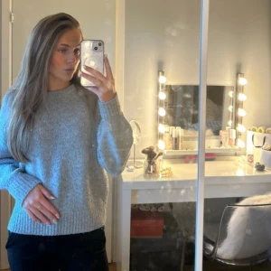 Grå stickad tröja från BikBok - Säljer en mysig grå stickad tröja från BikBok i storlek XS. Tröjan har en klassisk rund hals och långa ärmar, perfekt för kyligare dagar. Den är enkel att matcha med olika outfits och ger en stilren look. köpt för 600kr och använt ett fåtal gånger❤️