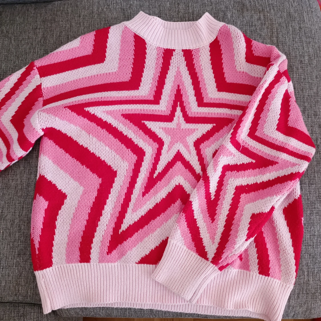 Rosa och röd stickad tröja med stjärnmönster