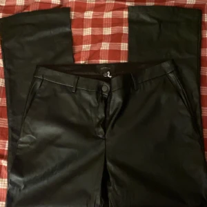 Skinnbyxor - Snygga svarta lågmidjade bootcut skinnbyxor från Alice Bizous i en stilren design. Byxorna har en knapp och dragkedja framtill. Fråga vid frågor! Passar M och är aldrig använda