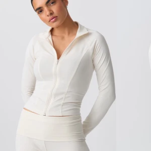 Vit långärmad tröja med dragkedja - Säljer min superfina tröja då den tyvärr inte kommer till användning. Clean girl inspirerande tröja med zip! Tröjan är aldrig använd men lappen är inte kvar, skriv för fler bilder!❤️