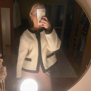 Vit jacka/kofta från H&M - Säljer en snygg vit jacka/kofta från H&M i storlek L. Jag är vanligtvis en S och den sitter oversize på mig! Den har svarta detaljer vid kanterna och fickorna, lite ”blair waldorf” vibes. Skicket visas på bilderna🥰
