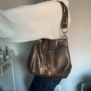 Väska - Sååå snygg väska! Jätte fin brun färg. Några skråmor men ingenting som jag tycker syns eller förstör användat av väskan. 