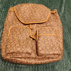 Calvin Klein Ryggsäck - Uppgradera din stil med en Calvin Klein ryggsäck! Elegant design, hög kvalitet och perfekt för både vardag och resor. Helt ny och i perfekt skick. Få både funktion och stil – skaffa din idag!     