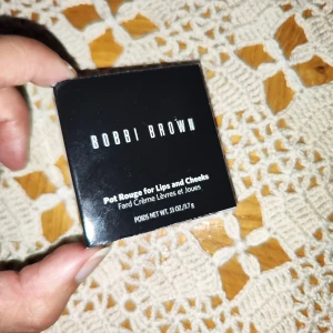 Bobbi Brown Pot Rouge for Lips and Cheeks - Säljer en Bobbi Brown Pot Rouge i färgen Powder Pink. Denna krämiga produkt är perfekt för både läppar och kinder, vilket ger en naturlig och fräsch look. Kommer i en smidig liten dosa som är lätt att ta med sig. Perfekt för att fräscha upp sminket under dagen!