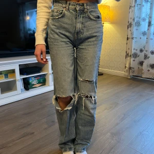 Blå jeans med slitningar från Perfect Jeans - Säljer ett par blå jeans från Perfect Jeans med slitningar! Dom är omsydda till ”low waist” 
