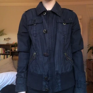 Svart jacka med knappar och dragkedjor - Snygg svart jacka med både knappar och dragkedjor. Står xl inuti men skulle säga S-M