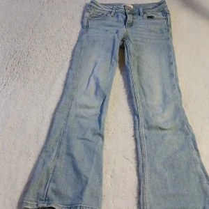 Ljusblå bootcut jeans - Snygga ljusblå bootcut jeans med klassisk femficksdesign. Perfekta för en avslappnad stil. De har en knapp och dragkedja framtill.