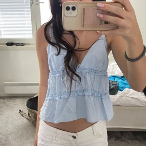 Volang topp - Blått ”volang” linne i nyskick. Har använt en gång så inga defekter. Storlek xs/s