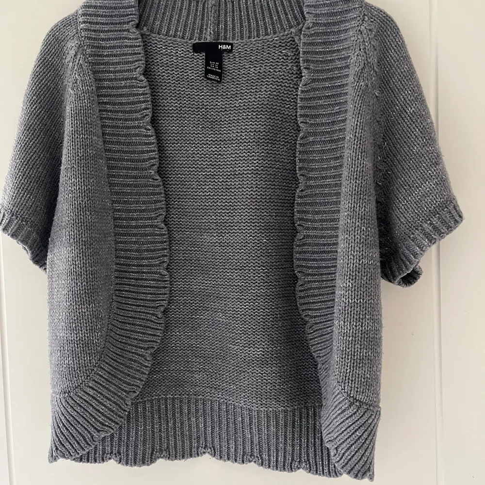 Säljer en stilren grå stickad kofta från H&M🩷. Koftan har korta ärmar och en öppen design med ribbade kanter. Perfekt för lager-på-lager och att hålla sig varm under kyliga dagar💞. Skriv vid frågor eller intresse💕. Neuletakit & Villapaidat.