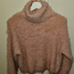 Mysig rosa fluffig tröja -  Nyskick Säljer en supermysig ljus rosa fluffig tröja med polokrage. Perfekt för kalla dagar när du vill känna dig både varm och stilren.Passar perfekt till både jeans och kjol!  Xs men mer som en S-M