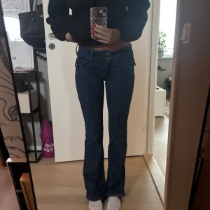Lågmidjade bootcut jeans - Snygga blå bootcut jeans med låg midja. Det är bra skick på dem men de saknar en knapp på fickan på framsidan.