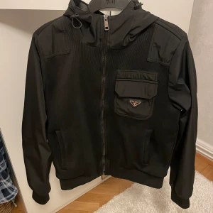 Prada cardigan  - Säljer en snygg svart jacka från Prada i storlek M. Den är perfekt för höst och vår med sin stilrena design och bekväma passform. Nypris 18 900 säljer min för 3299 . Priset är ej hugget i sten så hör av dig 