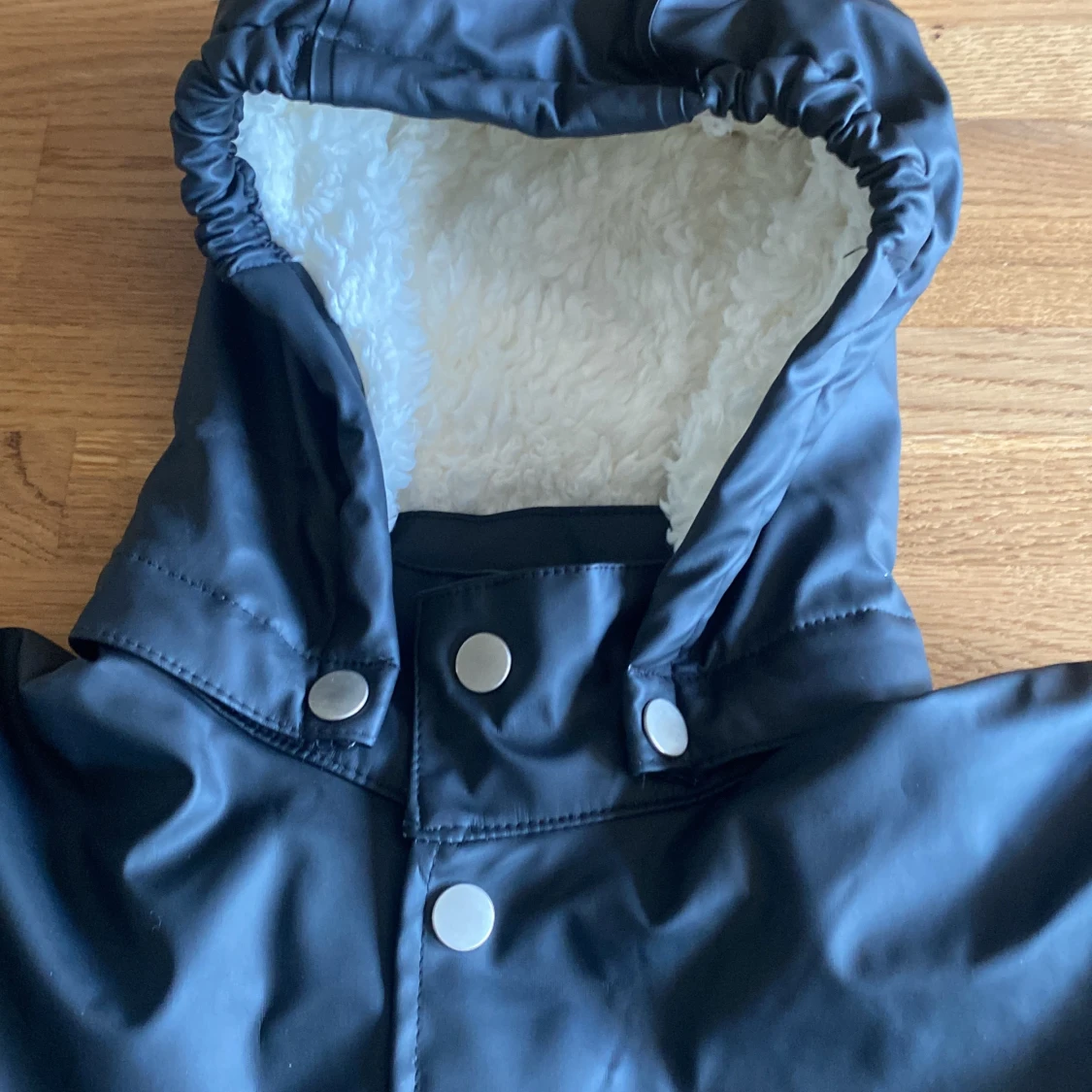 Svart regnkappa med fluffigt tyg inuti  - 91