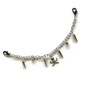 Silverfärgat accessoarsmycke - Coolt silverfärgat accessoarsmycke med hängande dödskalle och spikar. Sätt på väskan, bältet eller byxorna för att få en unik touch på din look. 🤟⭐️