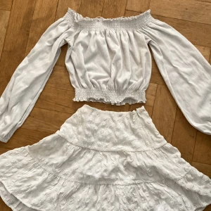 Vit offshoulder topp med en fin sommar kjol - Säljer en söt vit offshoulder topp med långa ärmar och elastiska kanter och en fin kjol perfekt för sommaren.