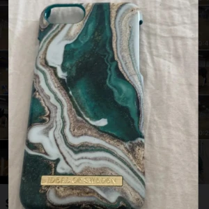 Mobilskal  - Två stilrena mobilskal från Ideal of Sweden. Det ena har ett marmorliknande mönster i grönt, vitt och guld, medan det andra har en klassisk vit marmordesign med svarta ådror. Perfekt för att ge din mobil en trendig look!