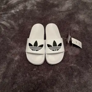 Säljer ett para vita tofflor från Adidas. De är helt nya och oanvända och är i väldigt bra kvalitet. Priset kan diskuteras. Skriv om ni undrar något.